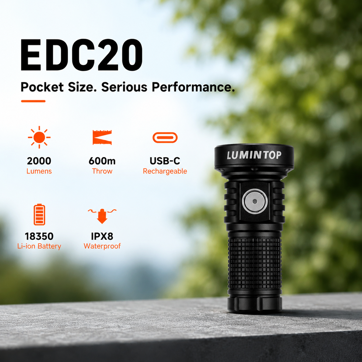 Lumintop EDC20 compact EDC flashlight black pocket size serious performance 2000 lumens 600 meters USB-C rechargeable 18350 Li-ion IPX8 waterproof outdoor green bokeh background