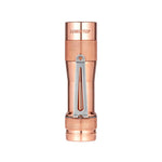 Lumintop FW3A copper flashlight standing upright, showing its polished body, knurled grip and pocket clip.