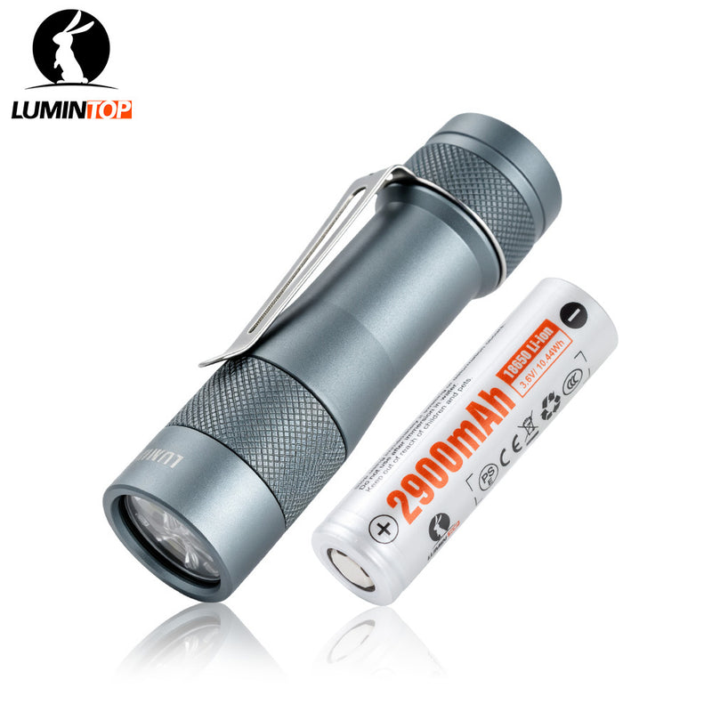 Lumintop FW3A grey aluminium EDC flashlight with pocket clip beside a 2900mAh 18650 battery.