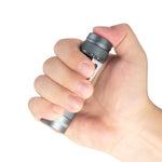 Hand holding a Lumintop FW3A grey aluminium flashlight with thumb on the electronic tail switch.