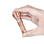 Lumintop GT Nano V3.0 copper compact EDC flashlight hand held finger grip tiny pocket size side switch diamond knurling white background